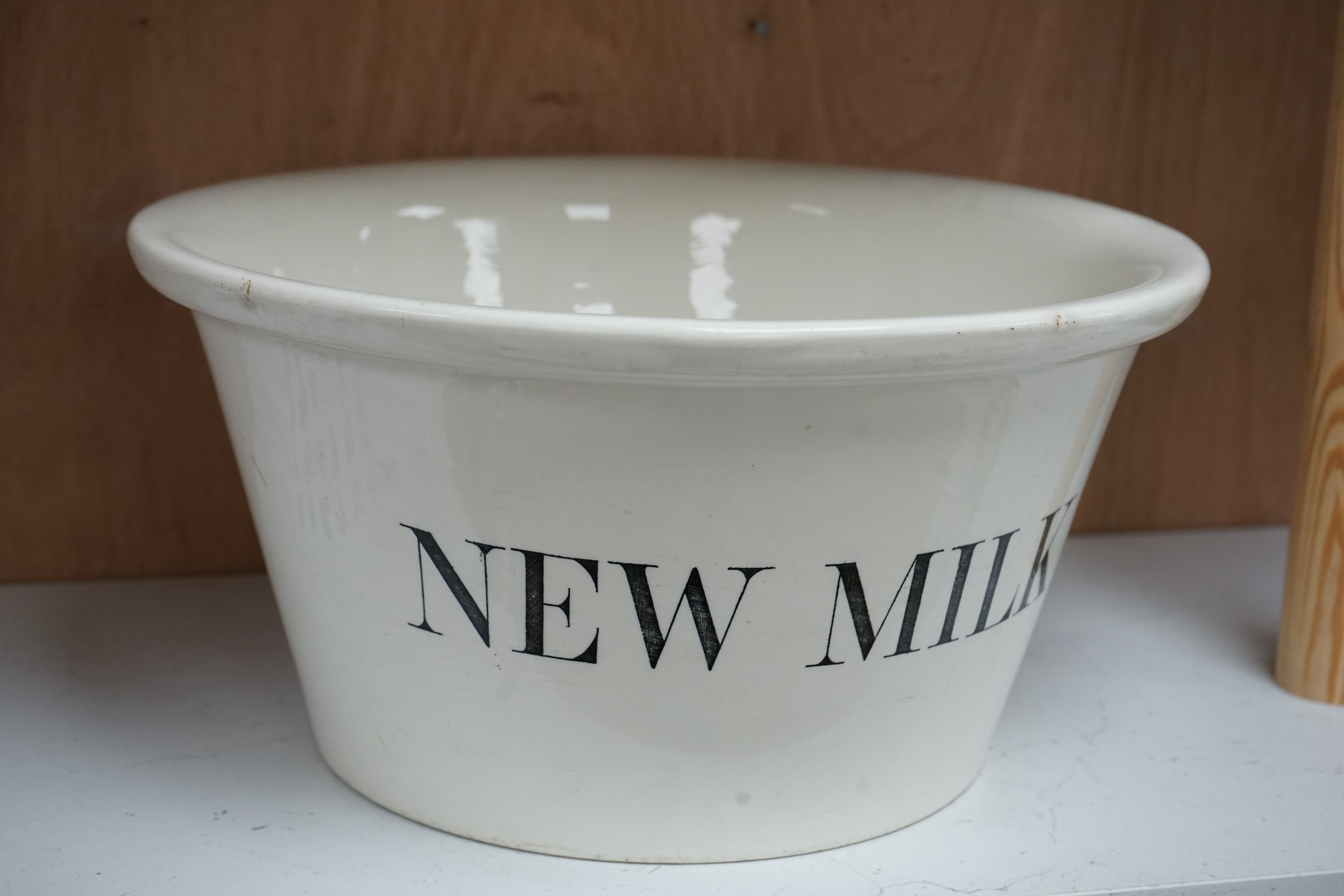 A Dairy Supply Co. Ltd 'New Milk' cream glazed dairy bowl, 34cm diameter. Condition - some marks to top edge of bowl.